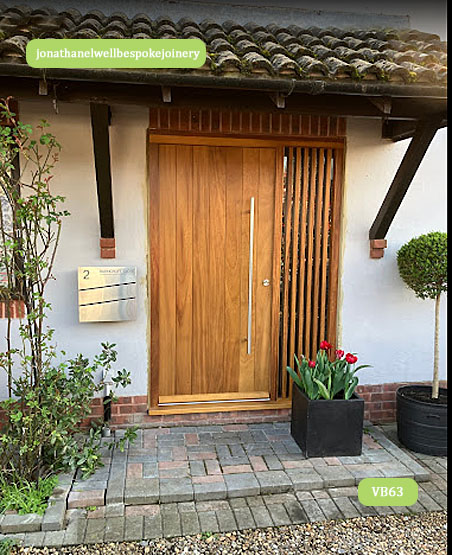 contemporary front door with wood slats sidelight